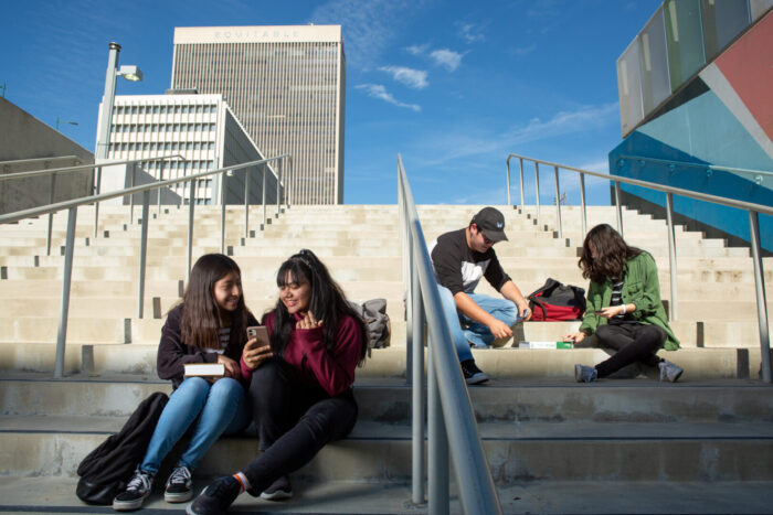 High school students gather on the stairs between classes.